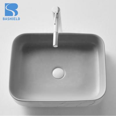 China Modern Black And White Hand Wash Solid Surface Ceramic Worktop Basin for sale