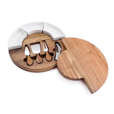 China Sustainable round shape acacia wood personalized wholesale cheese boards with cheese shooter, cutting board and knife set with dipping bowl for sale