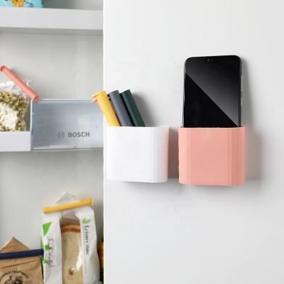 China Viable Design Small Self-adhesive Holder Sanga Storage Box Wall Mount Mobile Phone Socket Stand Remote Control Charging Stand for sale