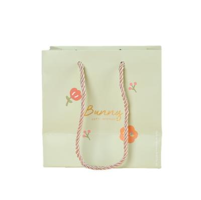 China Luxury Shopping Bag Pink Logo Recyclable Custom Paper Bag With Drawstring Transparent Hollow Portable Paper Packaging for sale