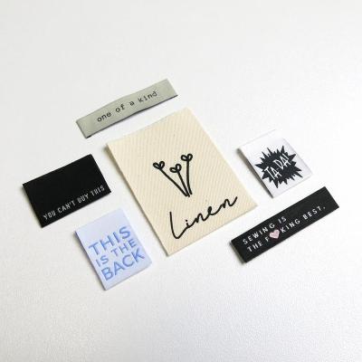 China Washable Custom Apparel Label Woven Polyester Personalized Logo Clothing Garment Woven T-shirt Label Wig Labels for sale