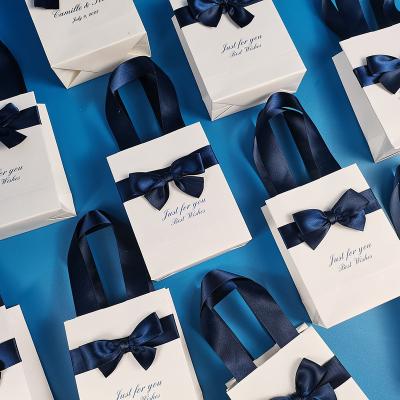 China Cute Luxury Handmade Wedding Printing Cosmetics Gift Shopping Paper Bags With Ribbon Bow for sale