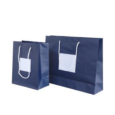 China Recyclable Custom Logo Printed Design Big Blue Shopping Bag For Mens Clothes Paper Bag Manufacturer for sale