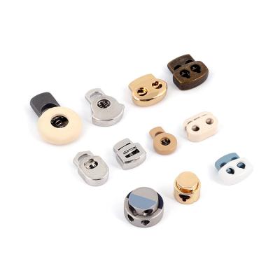 China Custom Zinc Alloy Engraved Stopper Nickel Free Bell Stopper Metal Cord Rope End Spring Lock Stopper for sale