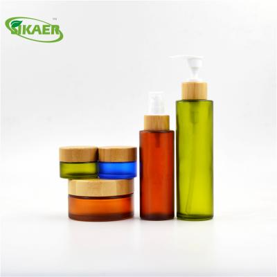 China Personal Care Biodegradable Bamboo Colored Glass Jar Cosmetic Packaging Perfume Bottles for sale