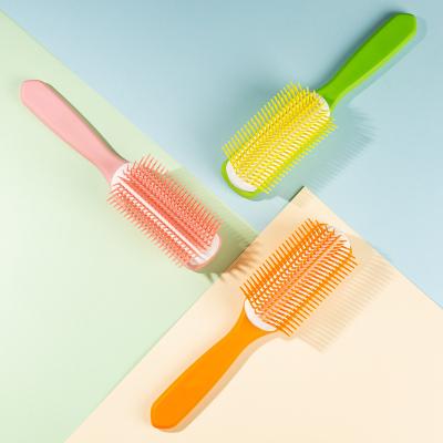 China 2022 new design colorful plastic handle paddle hair detangling 9 rows hair detangling comb with nylon bristle for salon for sale