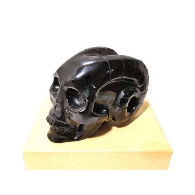 China Crystal Carving Wholesale Natural Black Obsidian China Stone Skulls Carving With Sheep Horns for sale