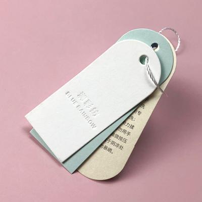 China Recyled Custom Design Printing Customer Logo Paper Garment Hang Tag Labels Clothing Hang Tags With String for sale