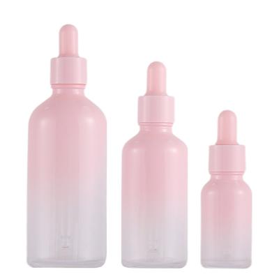 China Suitable for cosmetic packaging such as 5ml-100ml cosmetic essence smudge packaging material essence filled empty powder gradient cherry bottle pink glass dropper bottle for sale