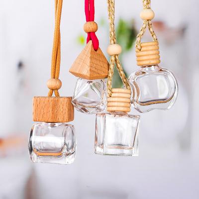 China Wooden Cap Empty White Air Freshener 8ml Essential Oil Perfume Car Diffuser Hanging Glass Bottle Wholesale Eco-friendly for sale