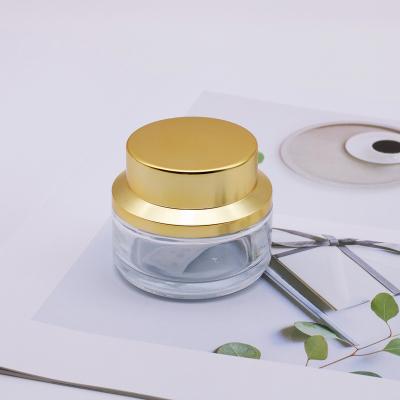 China Eco-friendly hot sale wholesaler skin care clear glass jars face cream cosmetic container with gold lid for sale