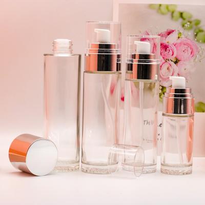 China Eco-friendly Manufacturer Cream Bottle Cosmetic Pump Lotion Clear Red Round Glass Bottle For Skin Care Packaging for sale