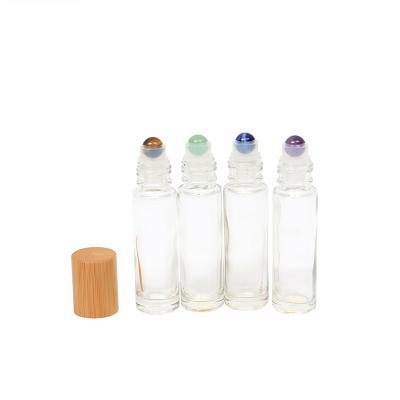 China Hot Selling Eco-friendly Empty Bamboo Cap Essential Oil Roller Bottles 10ml Clear Roll On Bottle Amber Glass For Perfume Essential Oil for sale