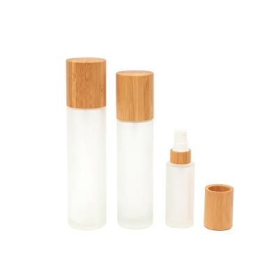 China Wholesale Custom Eco-friendly 50ml 100ml Bamboo Lid Frosted Glass Container Cosmetic Transparent Empty Spray Serum Lotion Pump Bottle for sale