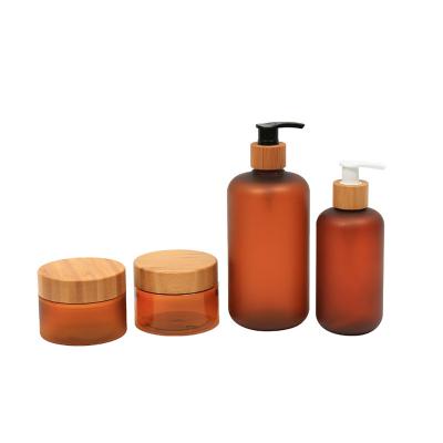 China Wholesale Eco-friendly 500ml Plastic Cosmetics Set Body Cream Jar With Bamboo Cap Amber PET Big Frosted Plastic Pump Shampoo Lotion Bottle for sale