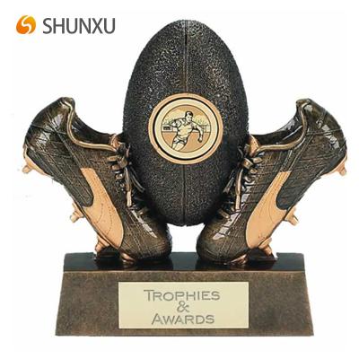 China Europe Polyresin Antique Black Bronze Rugby Ball And Boots With Custom Sport Game Text Engraved Event Reward Promotion Gift for sale