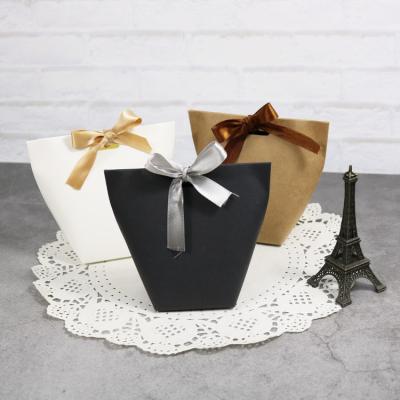 China Three Color Ribbon Bow Christmas Recyclable Luxury Paper Bag For Gifts for sale