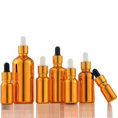 China Personal Care Wholesale Custom Serum Dropper Gold Glass Cosmetic Bottle for sale