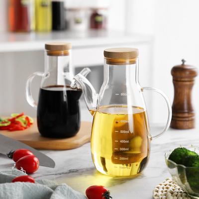 China Portable Glass Olive Oil Dispenser With Handle Pot Seasoner Drop Shape Kitchen Soy Vinegar Bottle Transparent Wholesale Viable Glass for sale