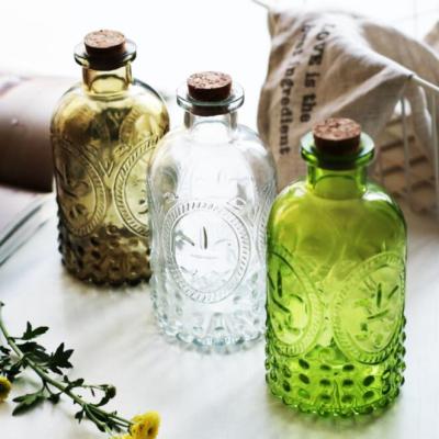 China Small Apperance 250ml luxury vintage aromatherapy embossed glass bottle sealed bottle with rattan and dry flowers for sale