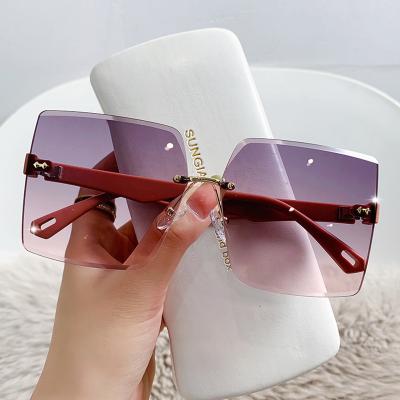 China Fashion Sunglasses 2022 Fashionable Hot Pink Women's Bling Rimless Sunglasses Bulk China Factory Direct Wholesale for sale