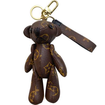 China Creative Cute Female Doll Key Chain Leather Flower Bear Doll Key Chain Ring Car Key Chain Bag Pendant for sale