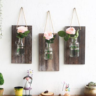 China Country Handmade Decor Bottle Glass Plant Wall Hanging Wooden Board Artificial Plants for sale