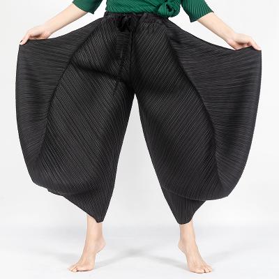 China Anti-Wrinkle Miyake Pleated Women Wide Leg Pants Asymmetrical Slimming Dangle Sense Plus Size Pants Knickers for sale