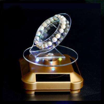 China Special ABS Solar Rotating Electric Jewelry Display Turntable / Acrylic Bangle Bracelet for sale