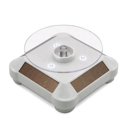 China Rotate 360 ​​Degree White LED Light Rotating Display Stand Battery Or Solar Powered Turntable for sale