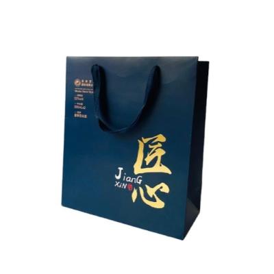 China Custom Printed Recyclable Critically Acclaimed Blue Glossy Laminated Retail Shopping Paper Bag With Logos for sale