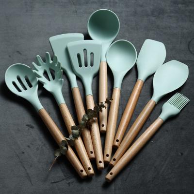 China Sustainable Kitchen Accessories Cooking Tools Kitchenware Silicone Kitchen Utensils With Wooden Handles for sale