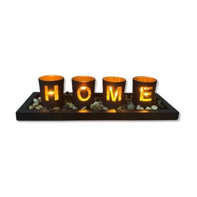 China Creative Fashionable Interior Decor Matt Black Glass Candle Jars with Wooden Tray with Stones Hollow Cut Glass Jars for sale