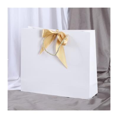 China Recyclable Shopping Gift Paper Bags Custom Logo Printing Colored Ivory Paper Handle Bag With Ribbons for sale