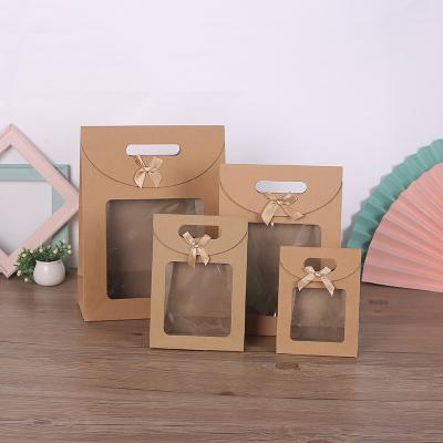 China Luxury Recycled Materials Jewelry Window Shopping Paper Packaging Bag With Bow Gift Apparel Cosmetic Shopping Paper Bag for sale