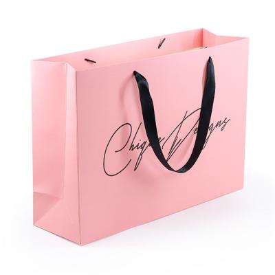 China Recyclable luxury pink ribbon art logo printing bag handle custom sacola bolsa de papel gift paper bag for boutique parties recyclable for sale