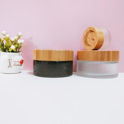 China Fashionable green cosmetic packaging luxury cosmetic jar glass jar with bamboo lid 15 30 50 100ml for sale