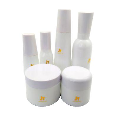 China Skin Care Cosmetic Packaging Essence Lotion Glass White Ceramic Set Bottle With Pump And Cream Jar for sale