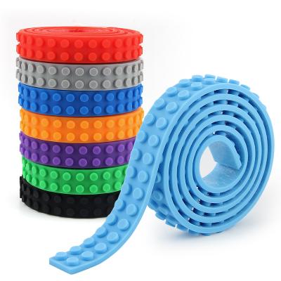 China 1M Continuous Silicone Toy Bricks Tape 2 Point 4 Dot Block Tape New Style Soft And Flexible Silicone Building Block Adhesive Tape for sale