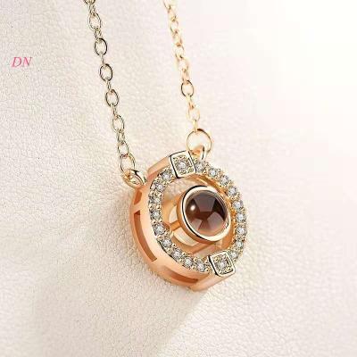 China Dina CLASSIC I love you 100 tongue necklace fashion jewelry round shaped charm necklace woman accessories custom projection necklaces for sale