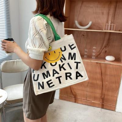 China 100% Eco-friendly Korean Women's Tote Bags With Smile Face Canvas Handheld Shopping Bag for sale