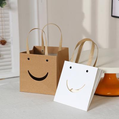 China Custom Recyclable Logo Cake Bakery Art Kraft Paper Box Recycled Smiley Design Bread Flower Square Gift Bottom Paper Bags With Handles for sale