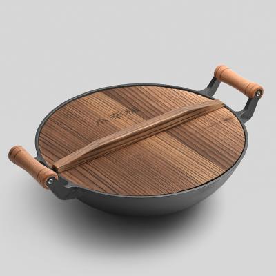 China Sustainable Wholesale Cost Effective Cast Iron Wok With Bottom Handle Wooden Household Wok for sale