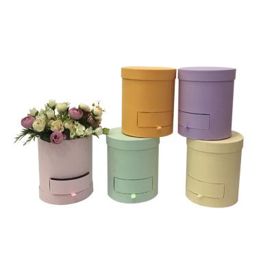 China Recycled materials wholesale custom small flower round bucket box simple product shooter hug bucket flower gift box for sale