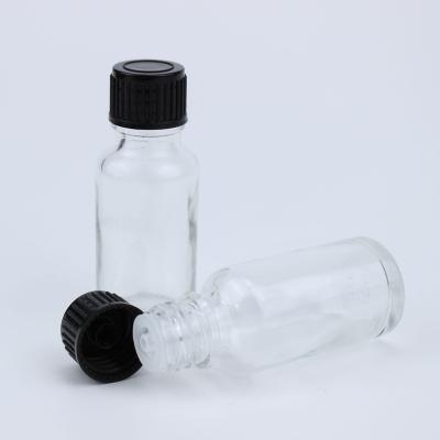 China Clear 20ml Essential Oil Round Glass Cosmetic Bottle With 18/415 Black Plastic Screw Cap for sale