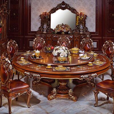 China Royal dining room furniture set classic European antique luxury chair solid wood gold leaf plated hand carved round dining table for sale