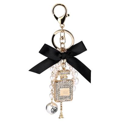 China Portable Crystal Rhinestone Perfume Bottle Keychain Stand Bag Luxury Pendant Charm New Product Ideas 2021 for sale