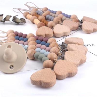 China BPA Free Silicone Food Grade Soother Holder Baby Pacifier Clip Baby Wooden Pacifier Chain for sale