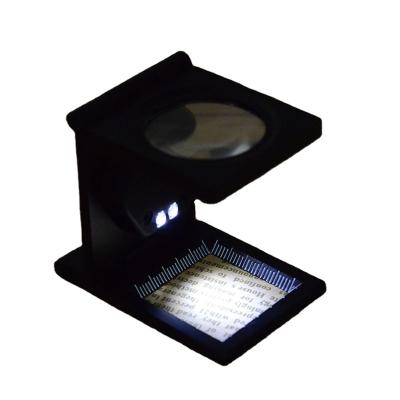 China TH-9005B Metal Scale Optical Glass Folding Optical Glass Magnifier With LED Light 8 Times Cloth Mirror Density for sale