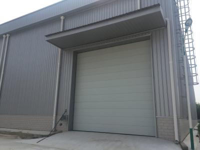 China Prefab Steel Structural Workshop Warehouse Wind Resist With Electric Rolling Up Shutter for sale